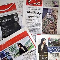 The front pages of Iranian newspapers featuring articles and photographs of Mahsa Amini, a woman who died three days after being arrested by the Islamic republic's 'morality police,' seen on September 18, 2022. (ATTA KENARE / AFP)