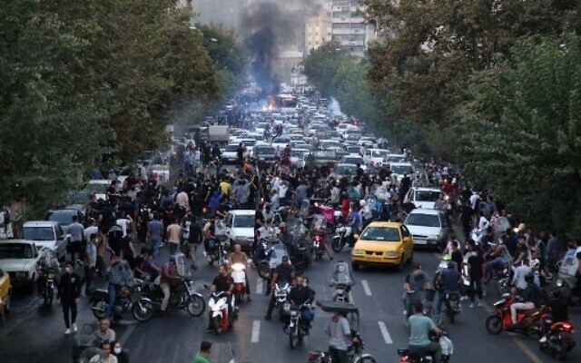A picture obtained by AFP outside Iran on September 21, 2022, shows Iranian demonstrators taking to the streets of the capital Tehran during a protest for Mahsa Amini, days after she died in police custody. (AFP)
