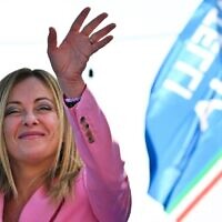Leader of Italian far-right party 'Fratelli d'Italia' (Brothers of Italy), Giorgia Meloni waves as she delivers a speech on September 23, 2022 at the Arenile di Bagnoli beachfront location in Naples, southern Italy, during a rally closing her party's campaign for the September 25 general election. (Andreas Solaro/AFP)
