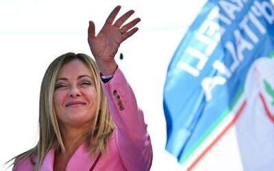 Leader of Italian far-right party 'Fratelli d'Italia' (Brothers of Italy), Giorgia Meloni waves as she delivers a speech on September 23, 2022 at the Arenile di Bagnoli beachfront location in Naples, southern Italy, during a rally closing her party's campaign for the September 25 general election. (Andreas Solaro/AFP)
