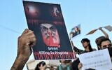 Illustrative: A protester holds a placard depicting Iran's Supreme Leader Ayatollah Ali Khamenei during a demonstration in Athens by Iranians living in Greece, September 24, 2022, following the death of an Iranian woman after her arrest by the country's morality police in Tehran. (Louisa Gouliamaki/AFP)