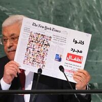Palestinian Authority President Mahmoud Abbas holds up a New York Times front page showing children killed in the May 2021 Israel-Hamas conflict as he addresses the 77th session of the United Nations General Assembly in New York on September 23, 2022 (Michael M. Santiago/Getty Images/AFP)