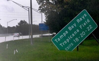 A damaged sign sits on the side of state road I-275 as Hurricane Ian approaches on September 28, 2022 in St. Petersburg, Florida. (GERARDO MORA / GETTY IMAGES NORTH AMERICA / Getty Images via AFP)