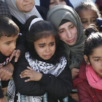 Palestinian women and children mourn during a funeral in the village of Tuqu  Tuesday, Jan. 17, 2017. (AP/Majdi Mohammed)