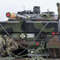 Illustrative: German army soldiers load a Leopard 2 tank onto a truck at the Sestokai railway station some 175 kms (109 miles) west of the capital Vilnius, Lithuania, Friday, Feb. 24, 2017. (AP Photo/Mindaugas Kulbis)