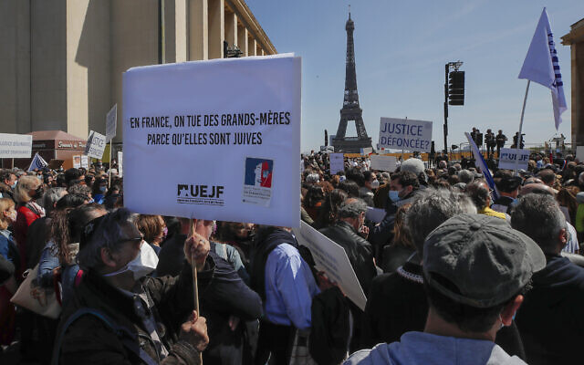 Illustrative: A man holds a placard that reads, 'In France grandmothers are killed because they are Jews,' during a protest organized by Jewish associations, who say justice has not been done for the killing of French Jewish woman Sarah Halimi, at Trocadero Plaza near Eiffel Tower in Paris, April 25, 2021. (AP Photo/Michel Euler)