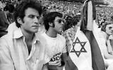 Israelis with a black crepe covered Israeli flag, photographed in the Munich Olympic stadium, September 6, 1972, during the memorial service for the 11 murdered Israeli team members. (AP Photo)