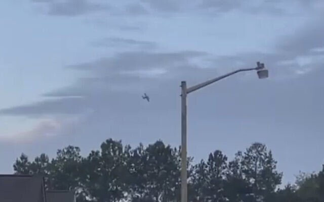 A pilot flies a small airplane over Tupelo, Mississippi while threatening to crash it into a local Walmart, September 3, 2022. (WCBI-TV via AP)