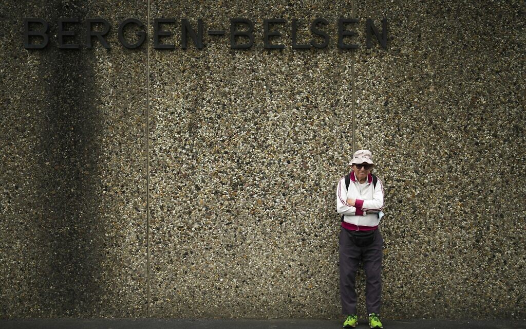 Israeli Olympic race walker Shaul Ladany poses for a photo at the entrance of the Nazi concentration camp Bergen-Belsen in Bergen, Germany, Sept. 3, 2022. (Markus Schreiber/AP)