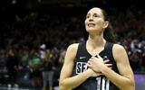 Seattle Storm guard Sue Bird puts her hands over her heart as she acknowledges fans chanting her name after her team was eliminated from the playoffs by the Las Vegas Aces in Game 4 of a WNBA basketball playoff semifinal, making it her last career game, Tuesday, Sept. 6, 2022, in Seattle. The Aces beat the Storm 97-92 to advance to the WNBA Finals. (AP Photo/Lindsey Wasson)