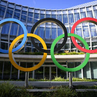 File: Olympic Rings are pictured in front of The Olympic House, headquarters of the International Olympic Committee (IOC) at the opening of the executive board meeting of the International Olympic Committee (IOC), in Lausanne, Switzerland, September 8, 2022. (Laurent Gillieron/Pool via AP)