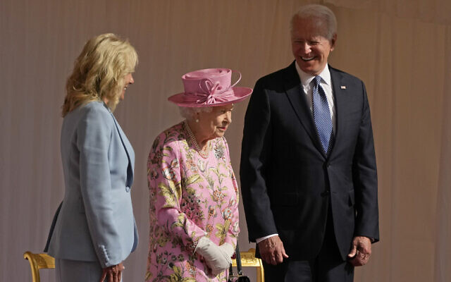FILE – US President Joe Biden and first lady Jill Biden smile while standing with Britain’s Queen Elizabeth II watching a Guard of Honour march past before their meeting at Windsor Castle near London, June 13, 2021. (AP Photo/Matt Dunham, Pool, File)