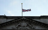 The Union flag on Buckingham Palace in London is lowered after the death of Britain's Queen Elizabeth II, September 8, 2022. (AP Photo/Frank Augstein)