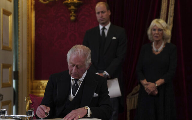 King Charles III signs an oath to uphold the security of the Church in Scotland during the Accession Council at St James's Palace, London, Sept. 10, 2022, where he is formally proclaimed monarch. (Victoria Jones/Pool Photo via AP)