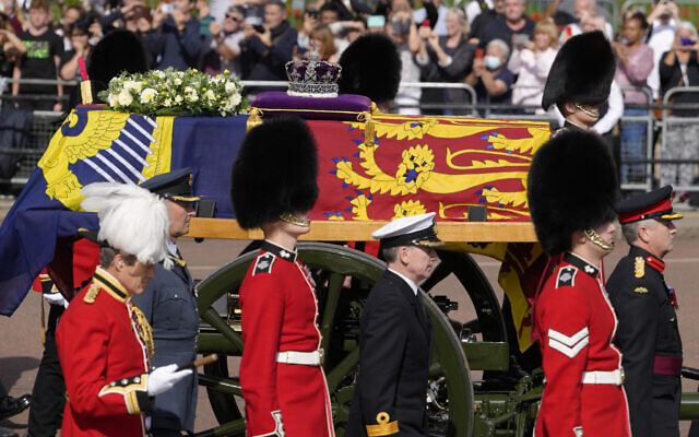 Grenadier Guards flank the coffin of Queen Elizabeth II during a procession from Buckingham Palace to Westminster Hall in London, Sept. 14, 2022. (AP Photo/Kirsty Wigglesworth)
