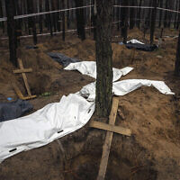 Bags with dead bodies are seen during the exhumation in the recently retaken area of Izium, Ukraine, Friday, Sept. 16, 2022. (AP Photo/Evgeniy Maloletka)