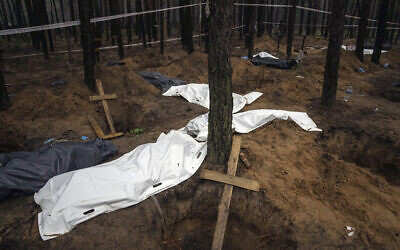 Bags with dead bodies are seen during the exhumation in the recently retaken area of Izium, Ukraine, Friday, Sept. 16, 2022. (AP Photo/Evgeniy Maloletka)