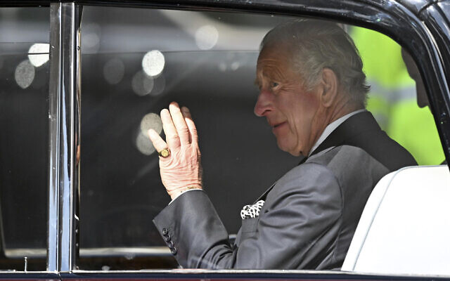 Britain's King Charles III waves as he leaves after a visit to the Metropolitan Police Service Special Operations Room (SOR) to thank Emergency Service workers for their work and support, ahead of the funeral of late Queen Elizabeth II, at the Lambeth headquarters in London, September 17, 2022. (Carl de Souza/Pool via AP)