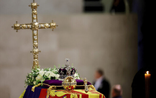 A view of Queen Elizabeth's coffin, draped in the Royal Standard, with the Imperial State Crown and the Sovereign's orb and scepter, and flowers on top, following her death, during her lying in state at Westminster Hall, in Westminster Palace, in London, September 18, 2022. (Sarah Meyssonnier/Pool Photo via AP)