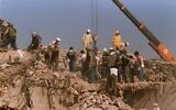 FILE - Rescue workers sift through the rubble of the US Marine base in Beirut in October 23, 1983 following a massive bomb blast that destroyed the base and killed 241 American servicemen. (AP Photo, File)