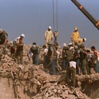 FILE - Rescue workers sift through the rubble of the US Marine base in Beirut in October 23, 1983 following a massive bomb blast that destroyed the base and killed 241 American servicemen. (AP Photo, File)