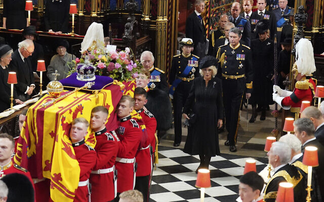 The coffin of Queen Elizabeth II is carried into Westminster Abbey, followed by King Charles III and other relatives, Sept. 19, 2022. (Dominic Lipinski/Pool via AP)