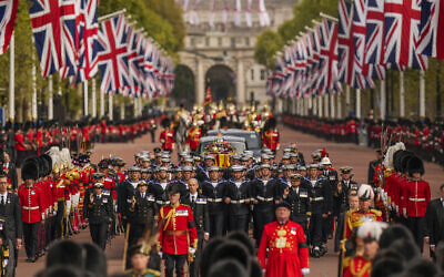 The coffin of Queen Elizabeth II is pulled past Buckingham Palace following her funeral service in Westminster Abbey in central London, September 19, 2022. (AP Photo/ Vadim Ghirda, Pool)