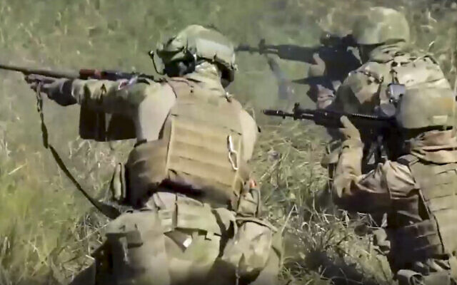 Illustrative: In this handout photo taken from video released by Russian Defense Ministry Press Service on Monday, September 19, 2022, members of a special forces unit of the Russian army aim their weapons in action at an unspecified location in Ukraine. (Russian Defense Ministry Press Service via AP)
