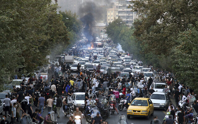 In this Wednesday, Sept. 21, 2022, photo taken by an individual not employed by The Associated Press and obtained by the AP outside Iran, protesters chant slogans during a protest over the death of a woman who was detained by the morality police, in downtown Tehran, Iran. (AP Photo)