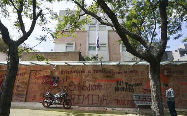 A motorcycle sits parked in front of Israel's embassy that was defaced by demonstrators demanding the extradition of the former director of Mexico’s Criminal Investigation Agency, Tomas Zeron, who is accused of torture, forced disappearances and judicial misconduct in the case of the 43 missing students of Ayotzinapa, in Mexico City, Wednesday, September 21, 2022. (AP Photo/Fernando Llano)