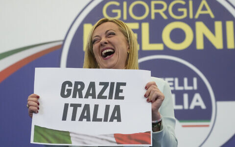 Far-Right party Brothers of Italy's leader Giorgia Meloni shows a placard reading in Italian 'Thank you Italy' at her party's electoral headquarters in Rome, September 26, 2022. (AP Photo/Gregorio Borgia)