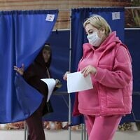 Voters exit booths after voting in a referendum at a polling station in Donetsk, the capital of Donetsk People's Republic controlled by Russia-backed separatists, eastern Ukraine, September 27, 2022. (AP Photo)