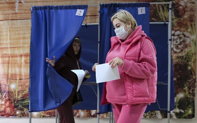 Voters exit booths after voting in a referendum at a polling station in Donetsk, the capital of Donetsk People's Republic controlled by Russia-backed separatists, eastern Ukraine, September 27, 2022. (AP Photo)
