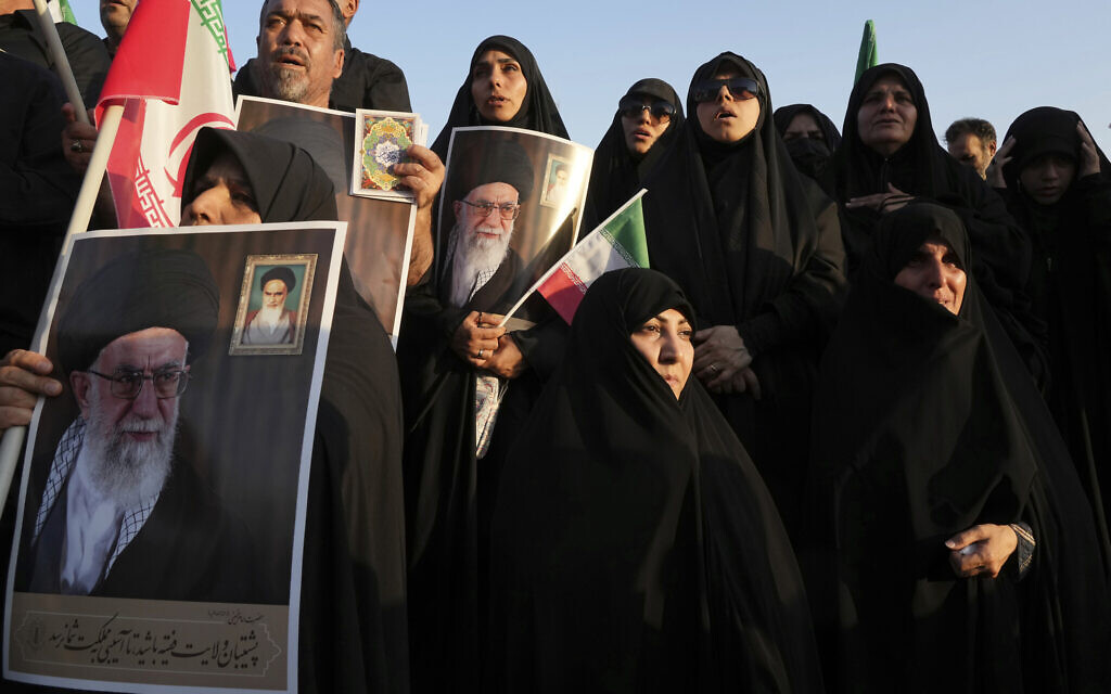 Iranian pro-government demonstrators hold posters of the Supreme Leader Ayatollah Ali Khamenei during their rally condemning recent anti-government protests over the death of Mahsa Amini, a 22-year-old woman who had been detained by the nation's morality police, in Tehran, Iran, Sunday, Sept. 25, 2022. (AP Photo/Vahid Salemi, File)