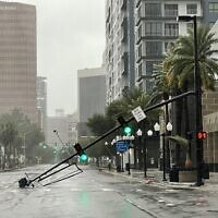 A stoplight pole at Livingston Street, blown down by Hurricane Ian winds, rests on Orange Avenue in Downtown Orlando, Florida, September 29, 2022. (Willie J. Allen Jr./Orlando Sentinel via AP)