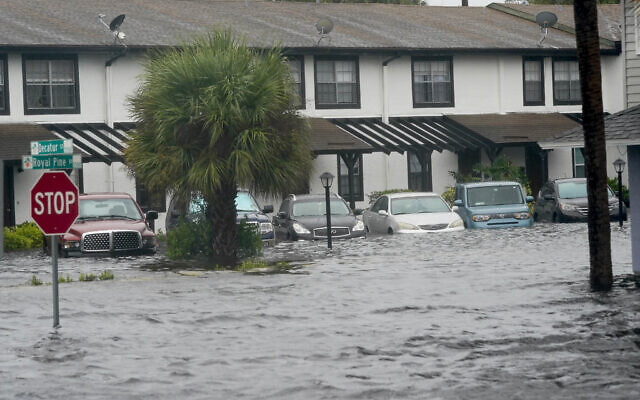 Vehicles sit in flood water at the Palm Isle apartments in the aftermath of Hurricane Ian, September 29, 2022, in Orlando, Florida. (AP Photo/John Raoux)