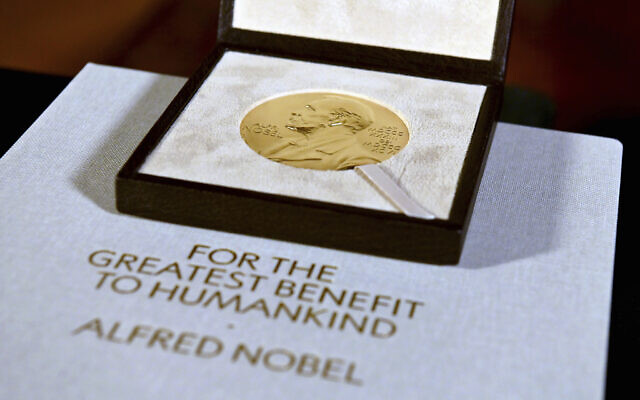 The Nobel diploma and medal in physiology or medicine presented to Charles M. Rice is displayed, Tuesday, Dec. 8, 2020, during a ceremony in New York.  (Angela Weiss/Pool Photo via AP, File)