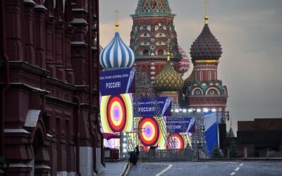 People make preparations for a concert at the Red Square, with constructions reading the words ''Donetsk, Luhansk, Zaporizhzhia, Kherson, Russia'', and the St. Basil's Cathedral and Lenin Mausoleum on the background, in Moscow, Russia, September 29, 2022. (AP Photo/Alexander Zemlianichenko)