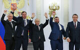 From left, Moscow-appointed head of Kherson Region Vladimir Saldo, Moscow-appointed head of Zaporizhzhia region Yevgeny Balitsky, Russian President Vladimir Putin, center, Denis Pushilin, the leader of the Donetsk People's Republic and Leonid Pasechnik, leader of self-proclaimed Luhansk People's Republic wave during a ceremony to sign the treaties for four regions of Ukraine to join Russia, at the Kremlin, Moscow, Friday, Sept. 30, 2022. (Mikhail Metzel, Sputnik, Kremlin Pool Photo via AP)