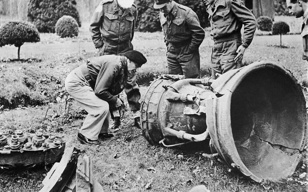 British officers examine a German V-2 rocket which fell and exploded in a field in Belgium on December 4, 1944. (AP Photo)