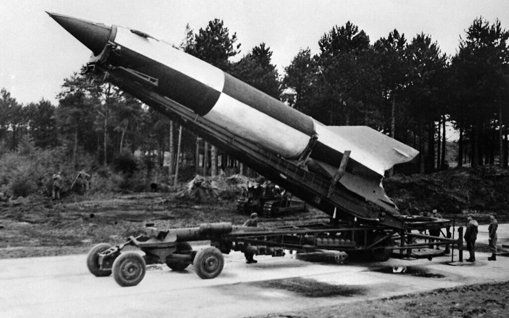 A rocket in process of elevation to the vertical firing position can be seen at the rear of the trailer at Cuxhaven, Germany, on October 15, 1945. (AP Photo)