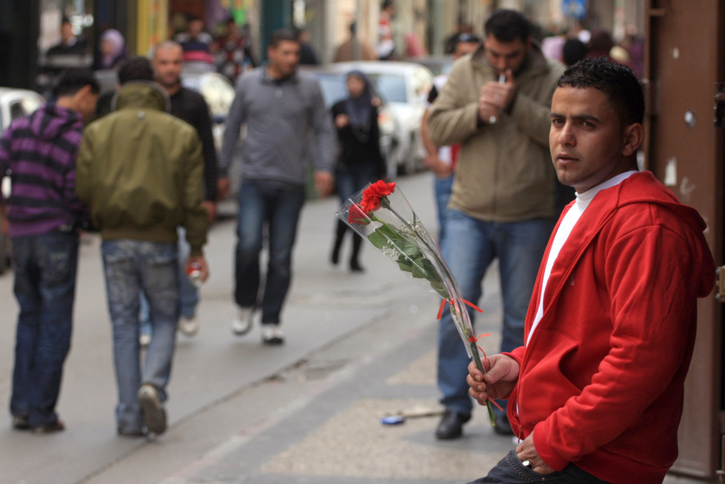 Illustrative: A Palestinian man sells roses on Valentine’s Day in the West Bank city of Ramallah, February 14, 2010. (Issam Rimawi/Flash90)