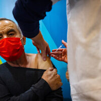 Illustrative image: a man receives his fourth dose of the COVID-19 vaccine, at a Clallit vaccine center in Jerusalem on January 3, 2022. (Olivier Fitoussi/Flash90)
