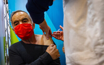 Illustrative image: a man receives his fourth dose of the COVID-19 vaccine, at a Clallit vaccine center in Jerusalem on January 3, 2022. (Olivier Fitoussi/Flash90)