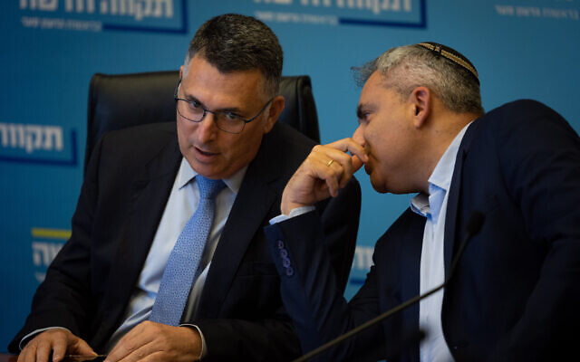 New Hope chairman Gideon Sa'ar (left) and Housing Minister Ze'ev Elkin speak during a faction meeting at the Knesset on June 20, 2022. (Yonatan Sindel/Flash90)