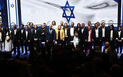 Prime Minister Yair Lapid poses with his Yesh Atid party's election candidates, in Tel Aviv, September 13, 2022. (Gideon Markowicz/Flash90)