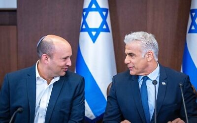 Prime Minister Yair Lapid, right, with Alternate Prime Minister Naftali Bennett at a cabinet meeting at the Prime Minister's Office in Jerusalem on September 18, 2022. (Olivier Fitousi/Flash90)