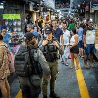 Israeli border police officers guard at the Mahane Yehuda Market in central Jerusalem on September 30, 2022. (Yonatan Sindel/Flash90)