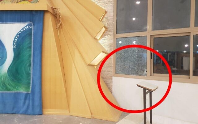 A shattered window at a yeshiva in the southern West Bank settlement of Carmel following a shooting attack, September 15, 2022. (Courtesy)