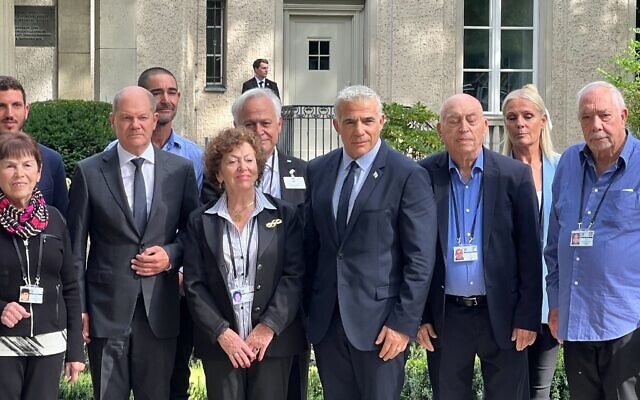 Prime Minister Yair Lapid (4R) and German Chancellor Olaf Scholz (3L) meet with Holocaust survivors and family members at the the House of the Wannsee Conference outside of Berlin on September 12, 2022 (Lazar Berman/Times of Israel)